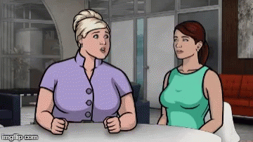 Two Women Sitting At Table Talking GIF