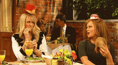 Two Women Sitting At Table With Man In Suit GIF