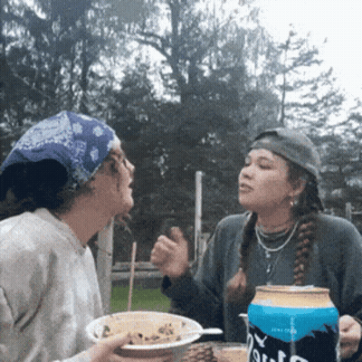 Two Women Sitting At Table With Pabst Beer GIF