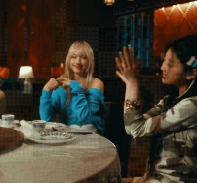 Two Women Sitting At Table With Plates And Cups GIF