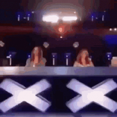 Two Women Sitting At Table With X GIF