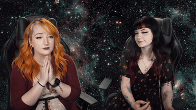 Two Women Sitting Hands Folded In Front Of Galaxy Background GIF