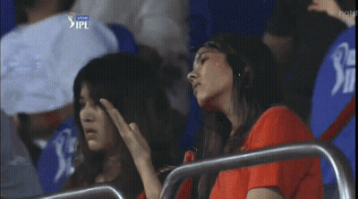 Two Women Sitting In A Stadium With Ipl Written On The Bottom GIF