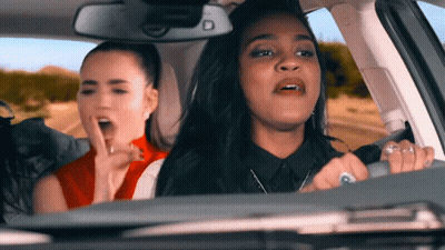 Two Women Sitting In Car With Letter D GIF