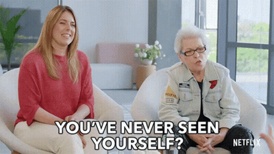 Two Women Sitting In Chairs One Asking If She Has Never Seen Herself GIF