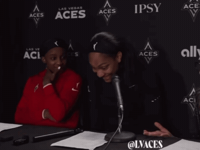 Two Women Sitting In Front Of Aces Wall GIF