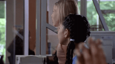 Two Women Sitting In Front Of Computer GIF