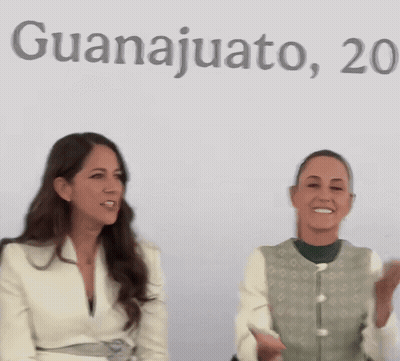 Two Women Sitting In Front Of Guanajuato Sign GIF