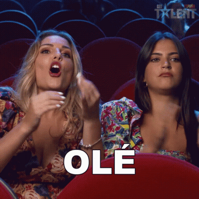 Two Women Sitting In Theatre Saying Ole GIF