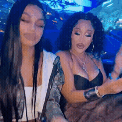 Two Women Sitting Next To Each Other In Restaurant GIF