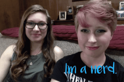 Two Women Sitting Next To Each Other Saying I'm A Nerd In Blue GIF