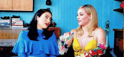 Two Women Sitting Next To Each Other Talking GIF