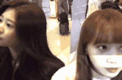 Two Women Sitting Next To Each Other GIF
