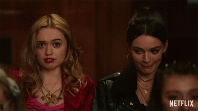 Two Women Sitting Next To Each Other With A Netflix Logo On The Bottom Right GIF