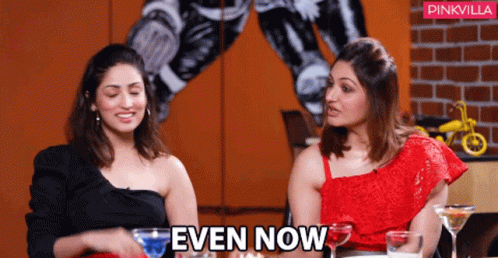 Two Women Sitting Next To Each Other With The Words Even Now Above Them GIF