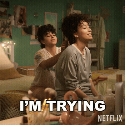 Two Women Sitting On Bed Saying I'm Trying GIF