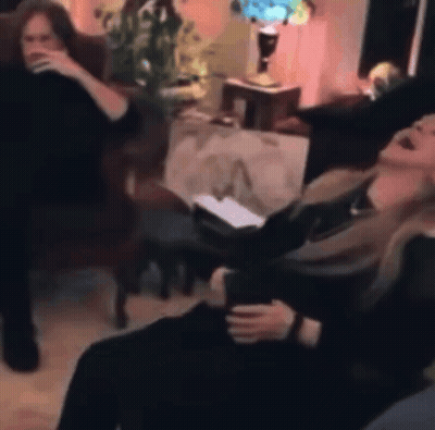 Two Women Sitting On Couch Laughing GIF