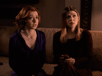 Two Women Sitting on Couch One Says Oh
