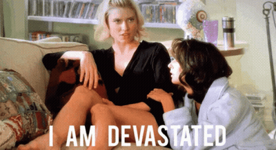 Two Women Sitting On Couch Saying I Am Devastated GIF