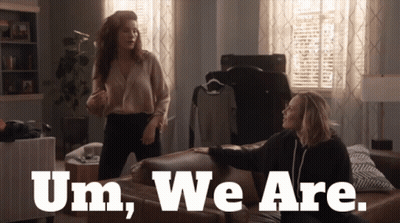Two Women Sitting On Couch Saying Um We Are GIF