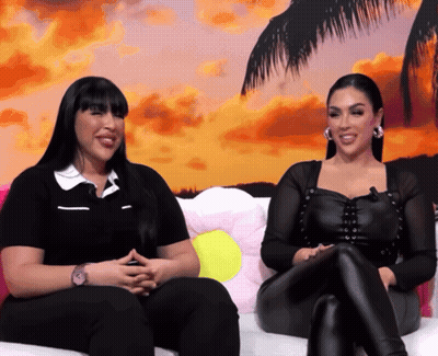 Two Women Sitting On Couch Smiling GIF