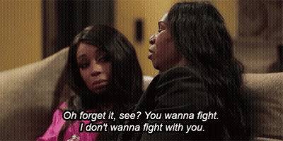 Two Women Sitting On Couch Talking About Fighting GIF