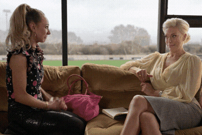 Two Women Sitting On Couch With Book GIF