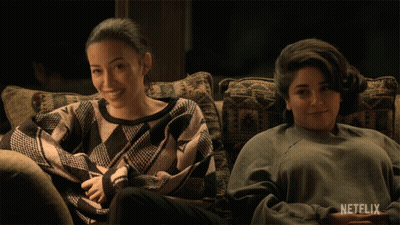 Two Women Sitting On Couch With Netflix Logo GIF