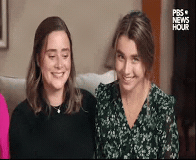 Two Women Sitting On Couch GIF