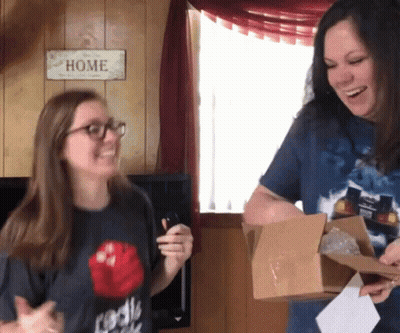 Two Women Smiling At Home Sign GIF