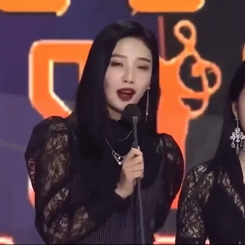 Two Women Smiling In Dark Room GIF
