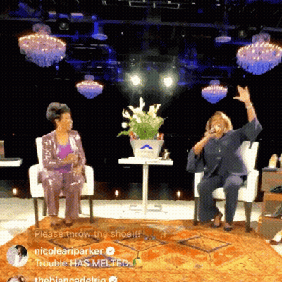 Two Women Stage Sign Throw The Shoe GIF