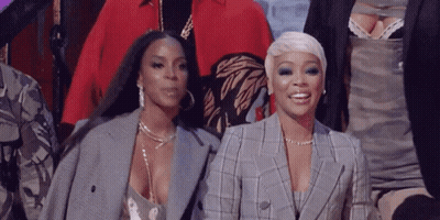 Two Women Standing And Smiling GIF