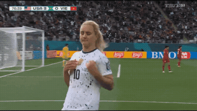 Two Women Standing By Brick Wall GIF