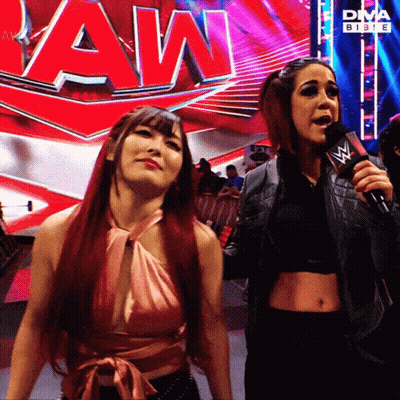 Two Women Standing By Raw Sign GIF