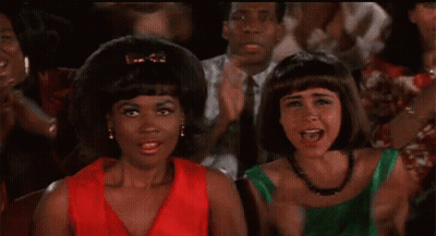 Two Women Standing In Crowd Applauding GIF