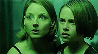 Two Women Standing In Dark Room GIF