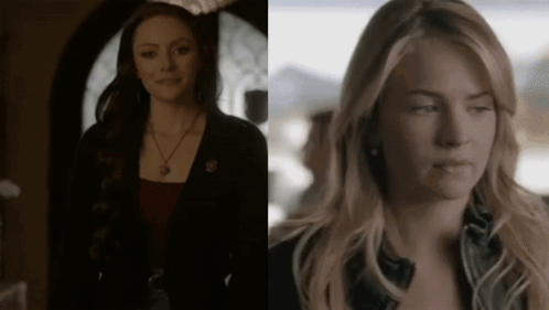 Two Women Standing In Dark Room One Wearing Necklace GIF
