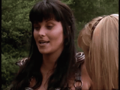 Two Women Standing in Forest Talking