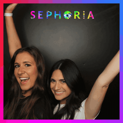 Two Women Standing In Front Of A Sign That Says Sephora GIF