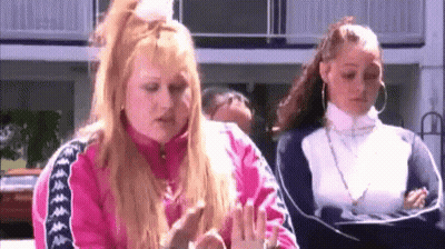 Two Women Standing In Front Of Building GIF