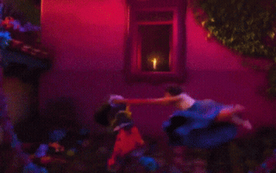 Two Women Standing In Front Of Candle GIF