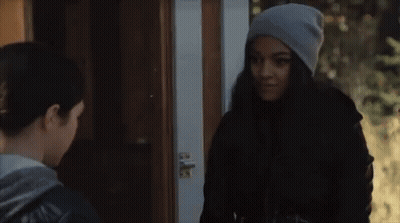 Two Women Standing in Front of Door Talking