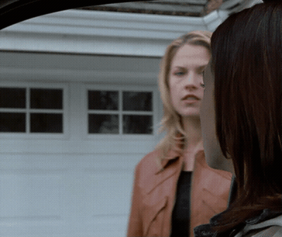 Two Women Standing In Front Of Garage GIF