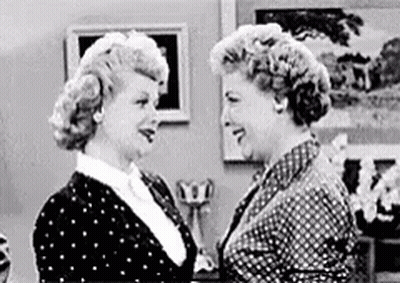 Two Women Standing In Living Room Looking At Each Other GIF