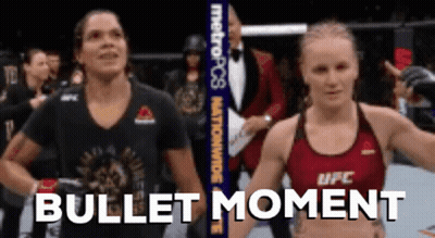 Two Women Standing Next To Each Other Bullet Moment GIF