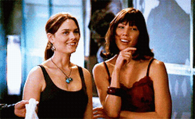 Two Women Standing Next To Each Other GIF