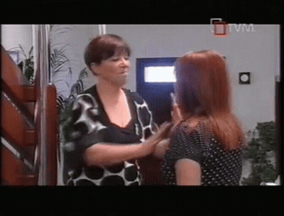 Two Women Standing Next To Each Other In A Room With A Tvm Logo On The Bottom Right GIF