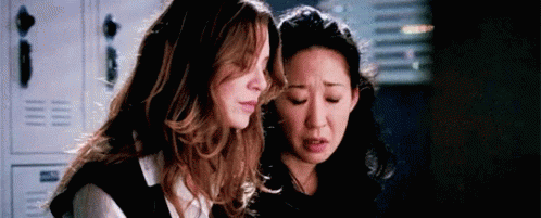 Two Women Standing Next To Each Other In Room With Lockers GIF
