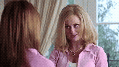 Two Women Standing Next To Each Other Looking GIF